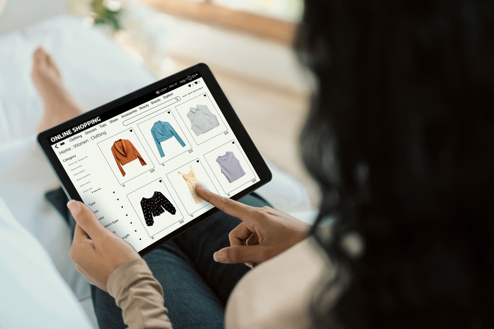 A shopper browsing an online clothing store on a tablet
