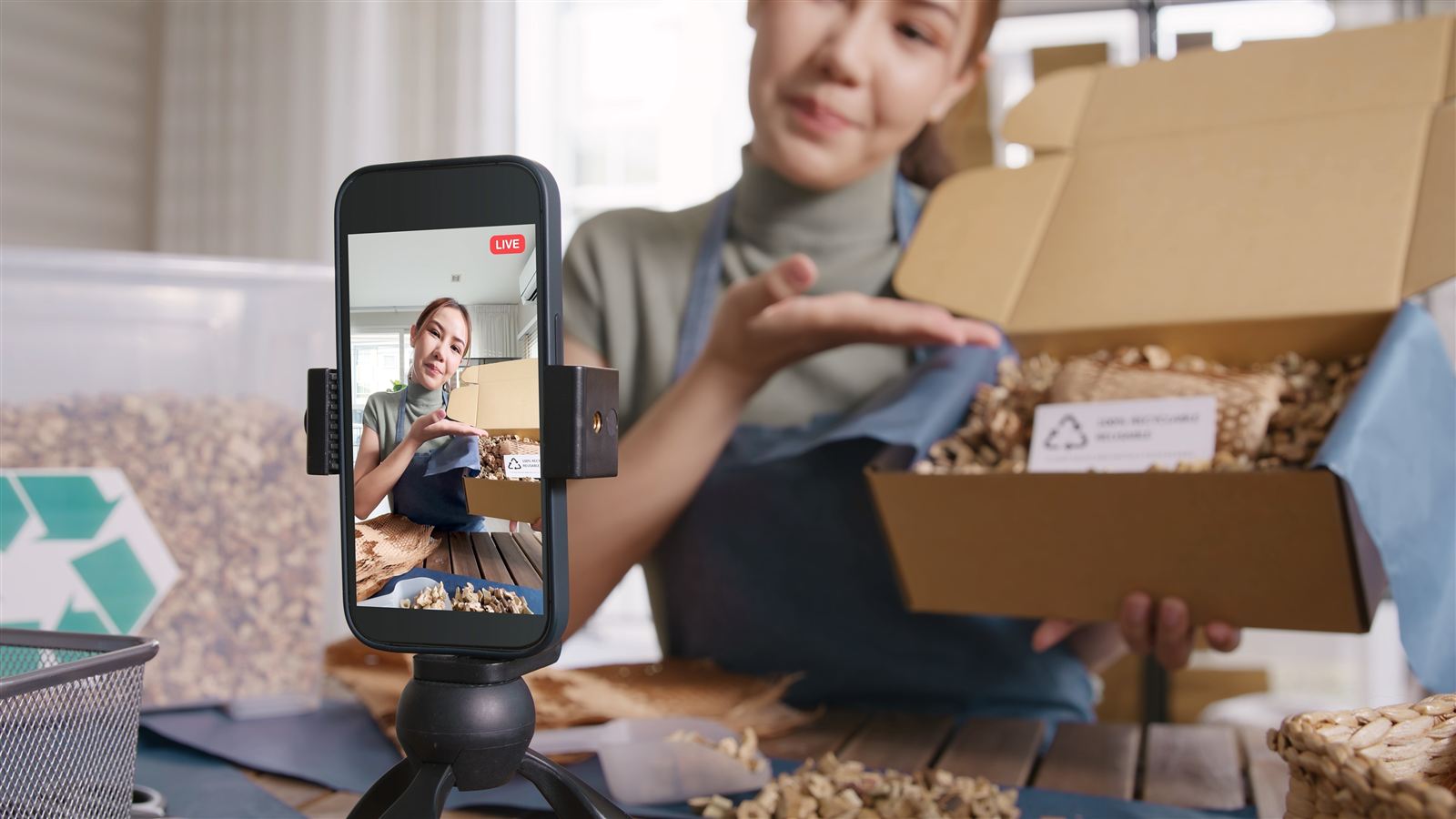 A seller filming a live sale of products packed in recyclable packaging